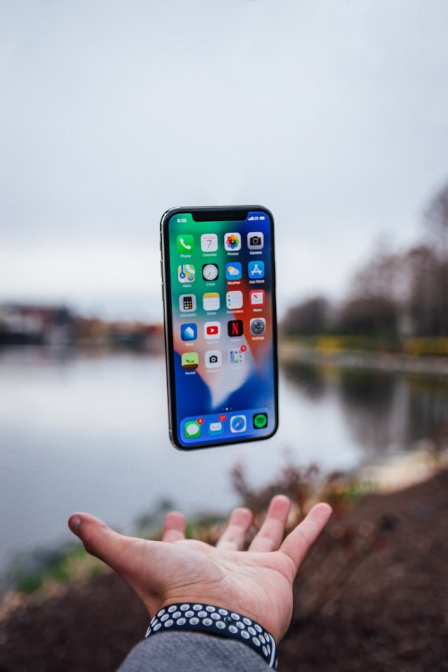 Cell Phone presented in hand.